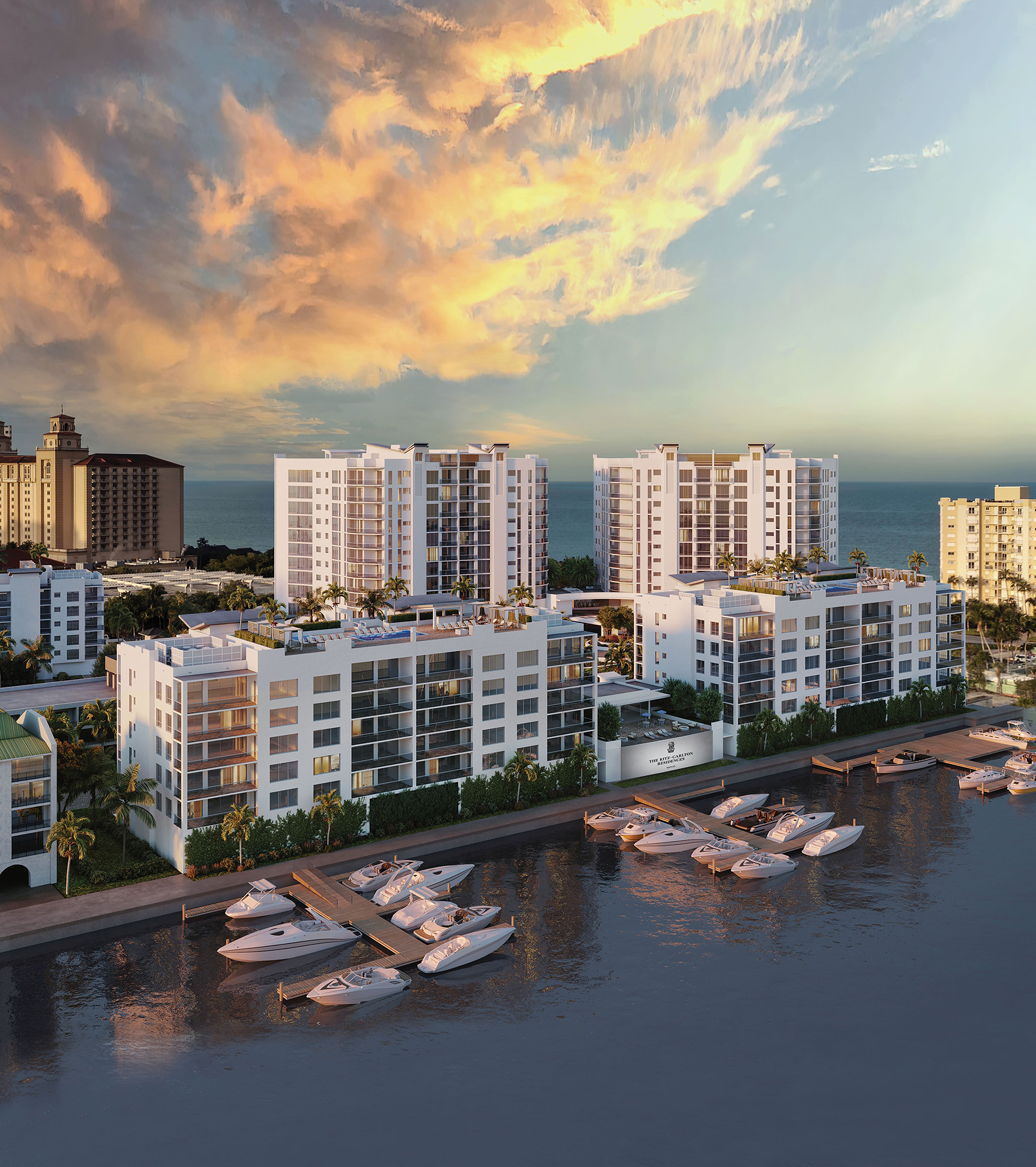 The Ritz-Carlton Residences Naples &mdash; aerial view of marina, towers, and Vanderbilt Lagoon at sunset with Gulf of Mexico in background