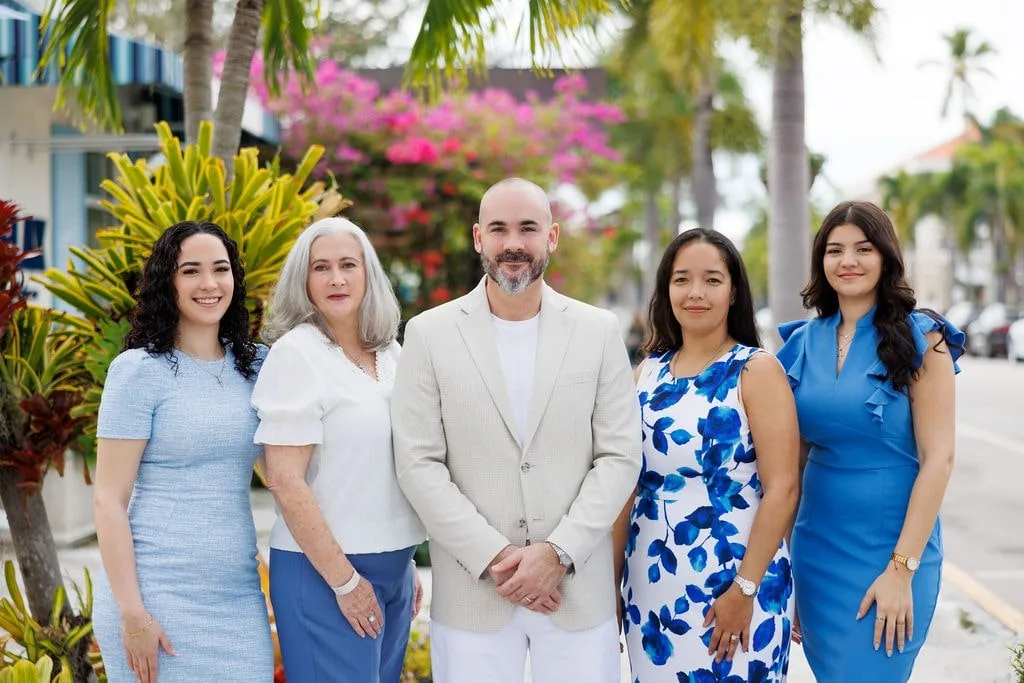 The Alpizar & Company real estate team in Naples, Florida &mdash; Robert and Marlene Alpizar with the firm's advisors