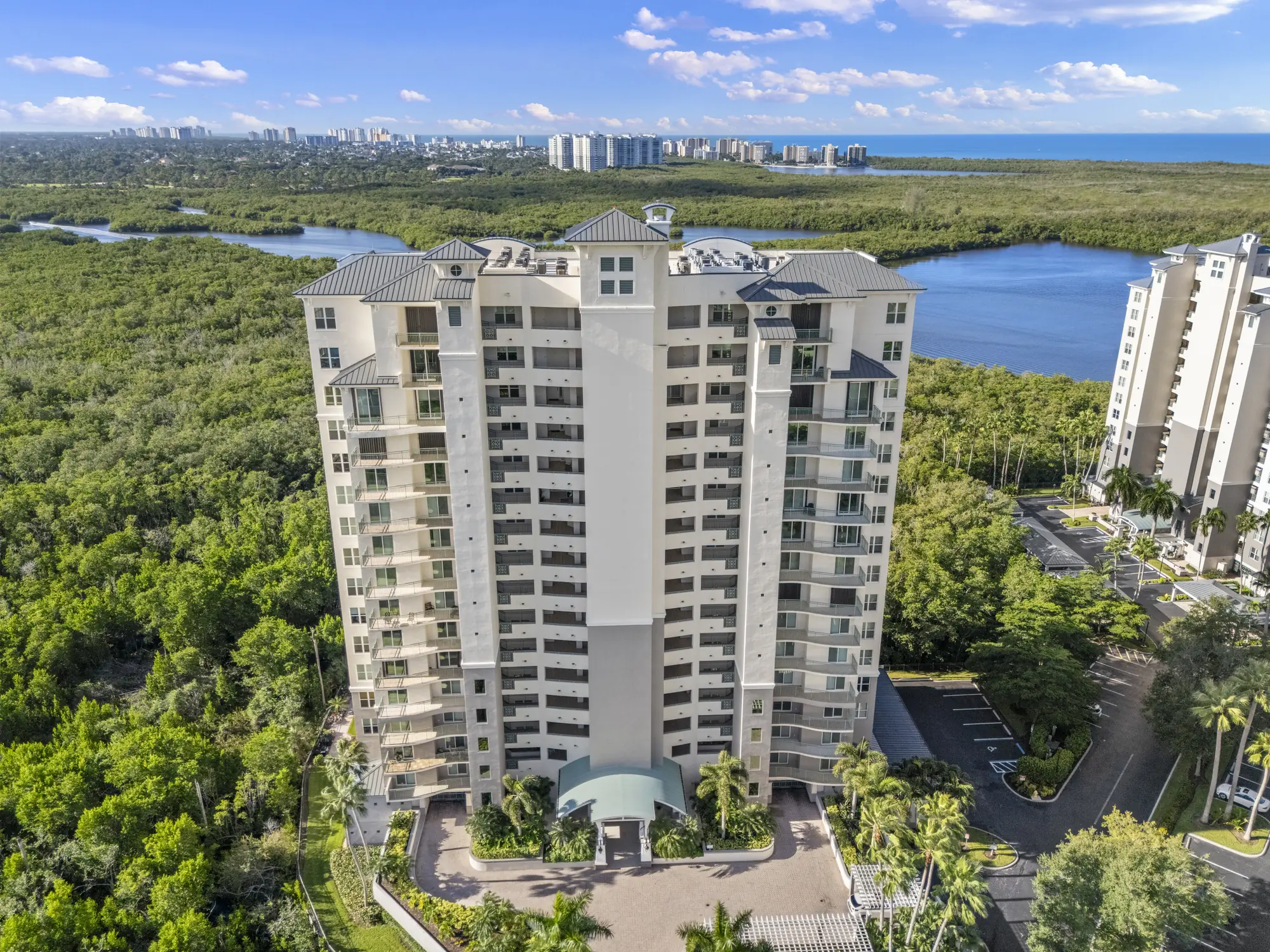 Aerial of Caribe at Cove Towers, 425 Cove Tower Drive, a high-rise above the mangrove preserve in North Naples, Florida