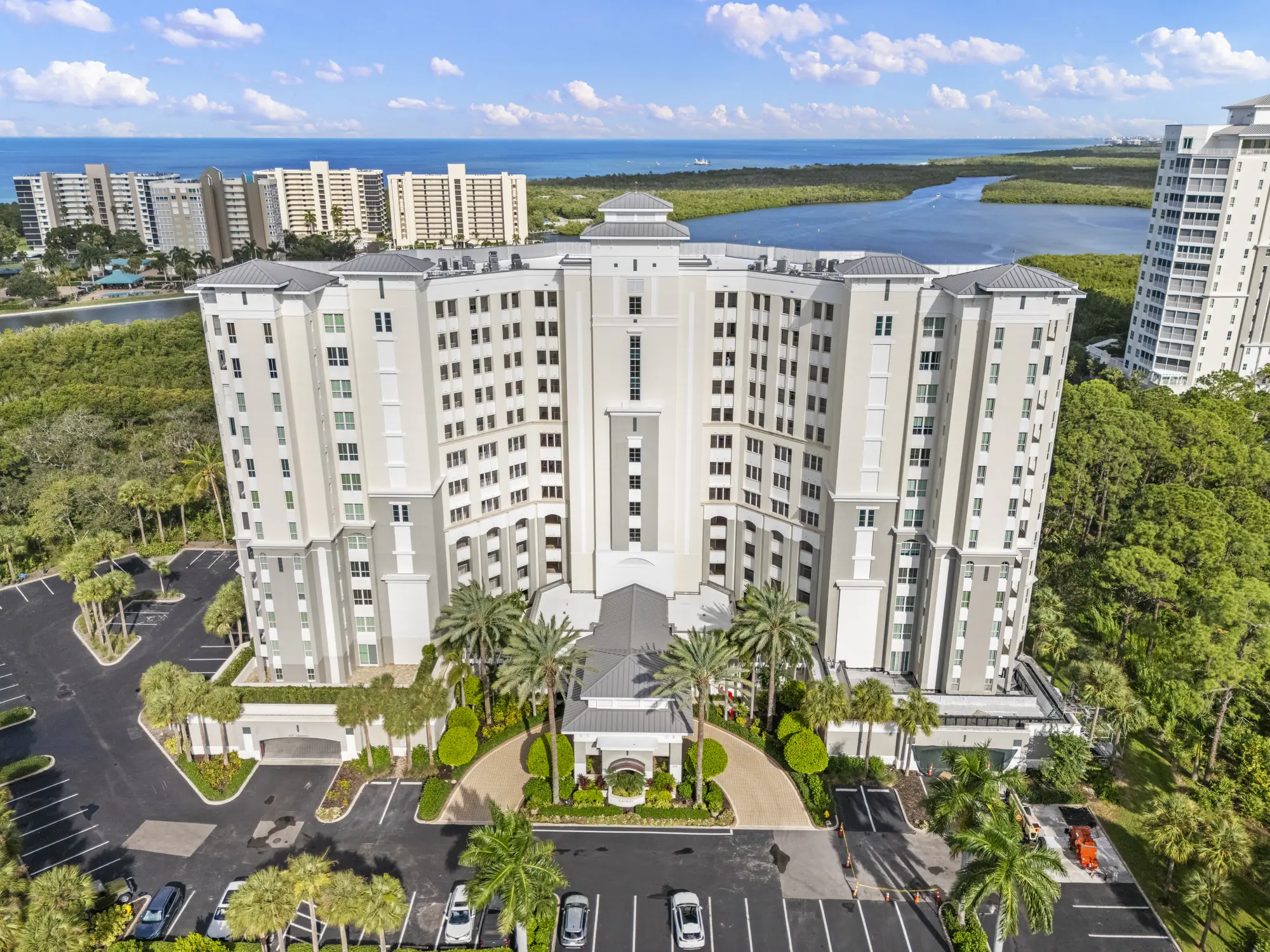 Aerial of Cayman, one of the three Island Cove towers at The Dunes of Naples, with Turkey Bay and the Gulf beyond