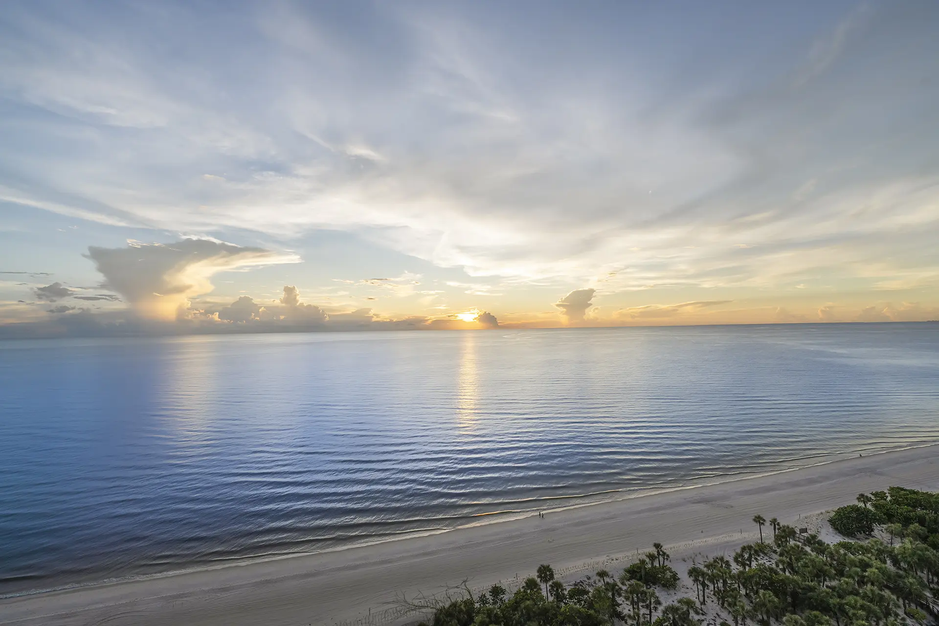Sunset over the Gulf of Mexico and the beach from a terrace at Contessa at Bay Colony, Naples, Florida