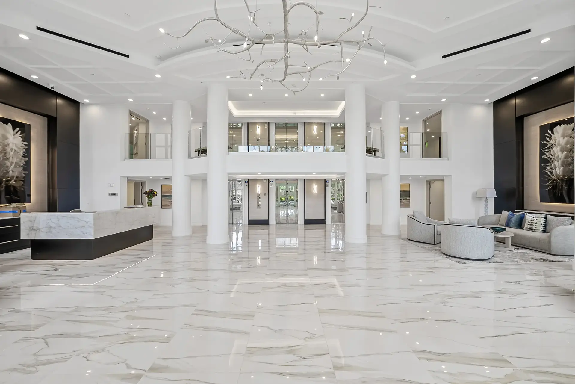 Two-story marble lobby with branch chandelier at Contessa at Bay Colony, Naples, Florida