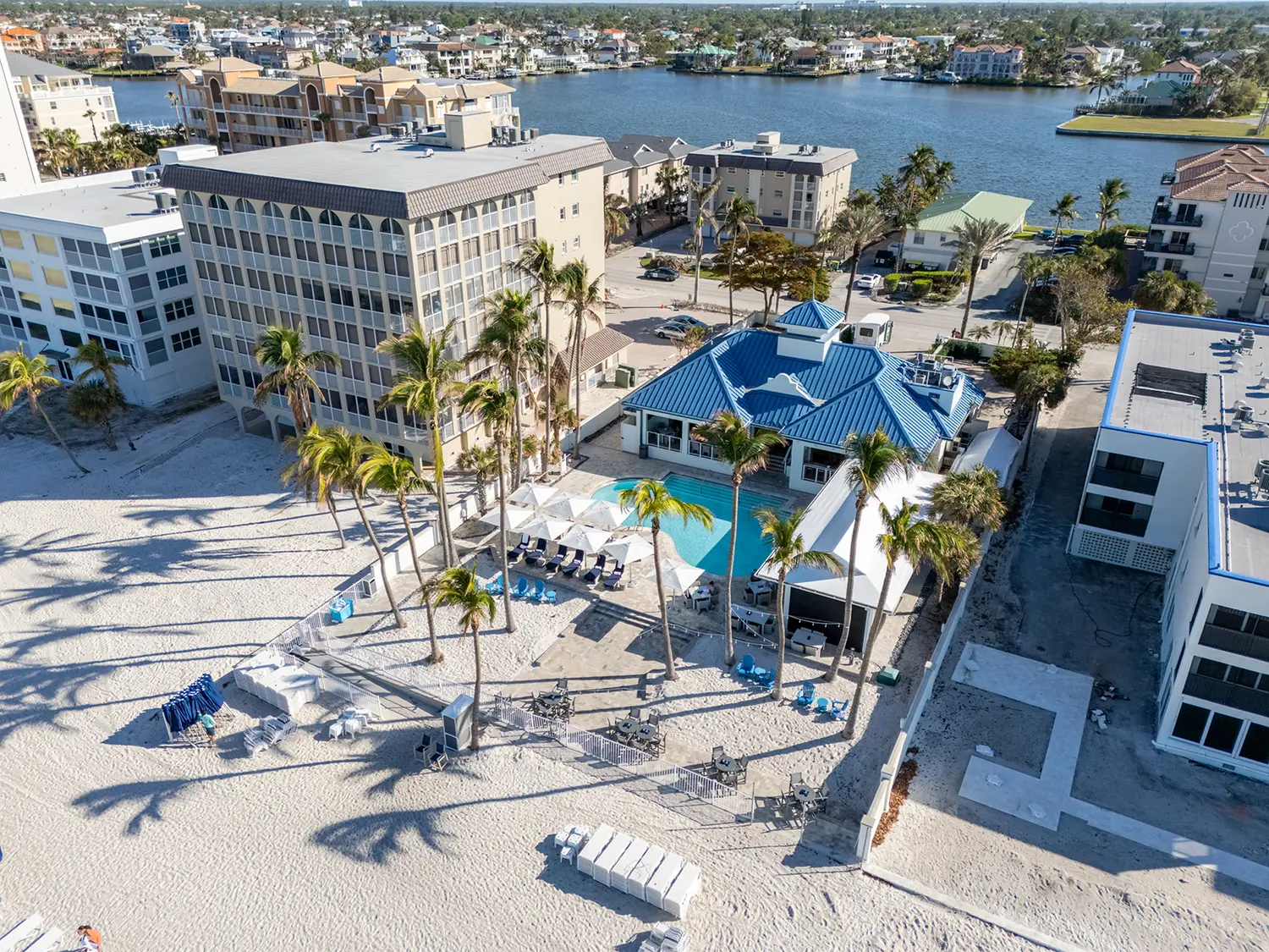 Aerial view of the Floridian Club, the private beach club for The Dunes of Naples on Vanderbilt Beach, with its pool, cabanas and beachfront lounges