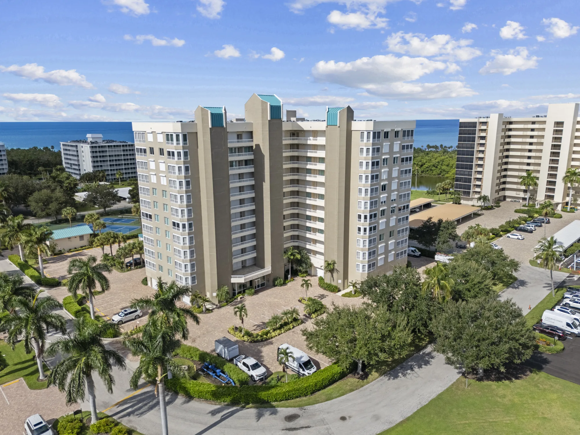 Aerial of the Gulf Breeze at Vanderbilt tower at 21 Bluebill Avenue, an eleven-story high-rise, with the Bluebill Avenue towers and the Gulf of Mexico beyond, Vanderbilt Beach, Naples, Florida