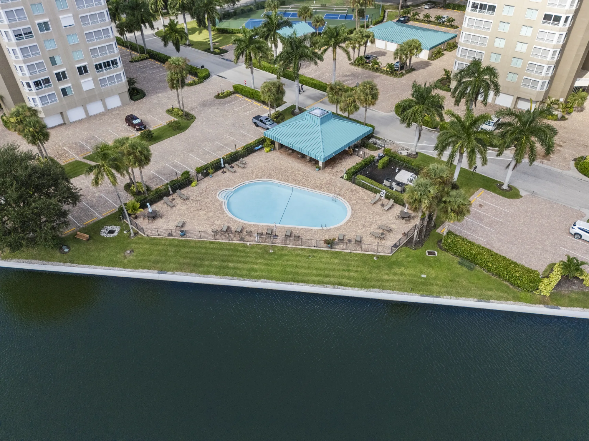 Aerial of the Gulf Breeze at Vanderbilt pool and pavilion on the channel between its towers at 21 and 25 Bluebill Avenue, Vanderbilt Beach, Naples, Florida