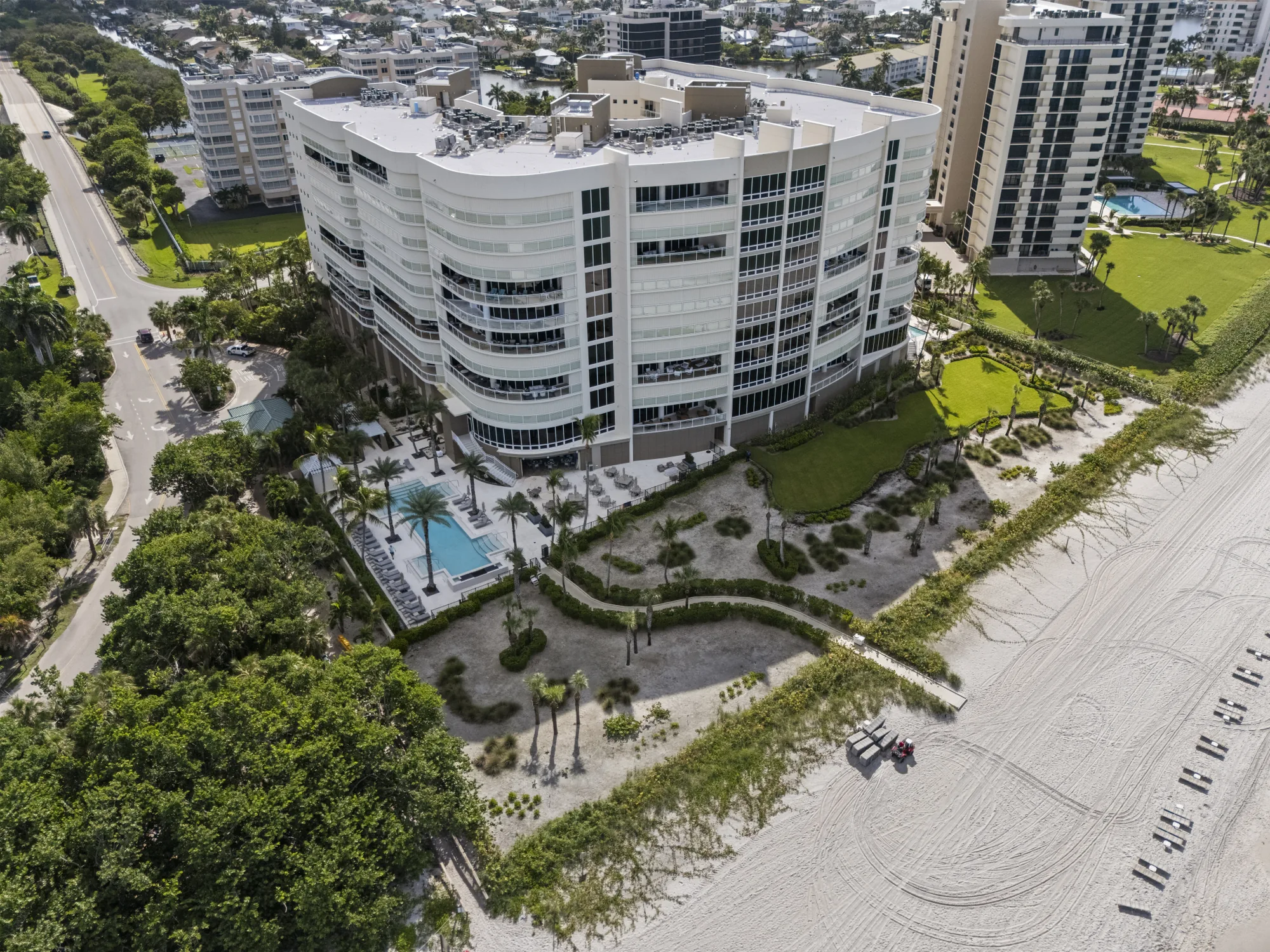 Aerial of the Moraya Bay pool deck, gardens and beach walkway on the Gulf at the north end of Vanderbilt Beach, Naples, Florida