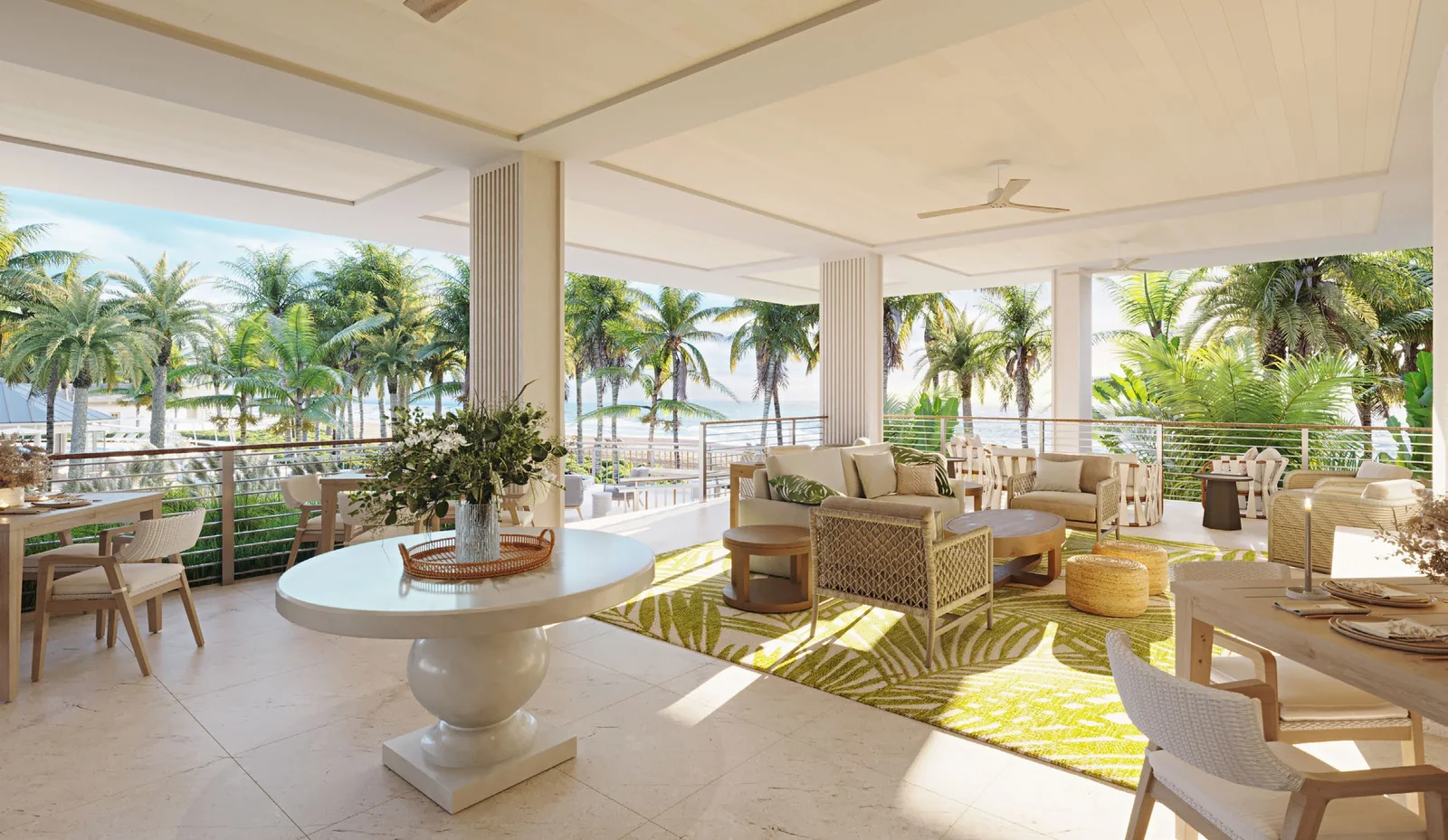 The Residents’ Club outdoor living room at Naples Beach Club, a covered terrace with lounge seating, a round table and palms opening toward the Gulf