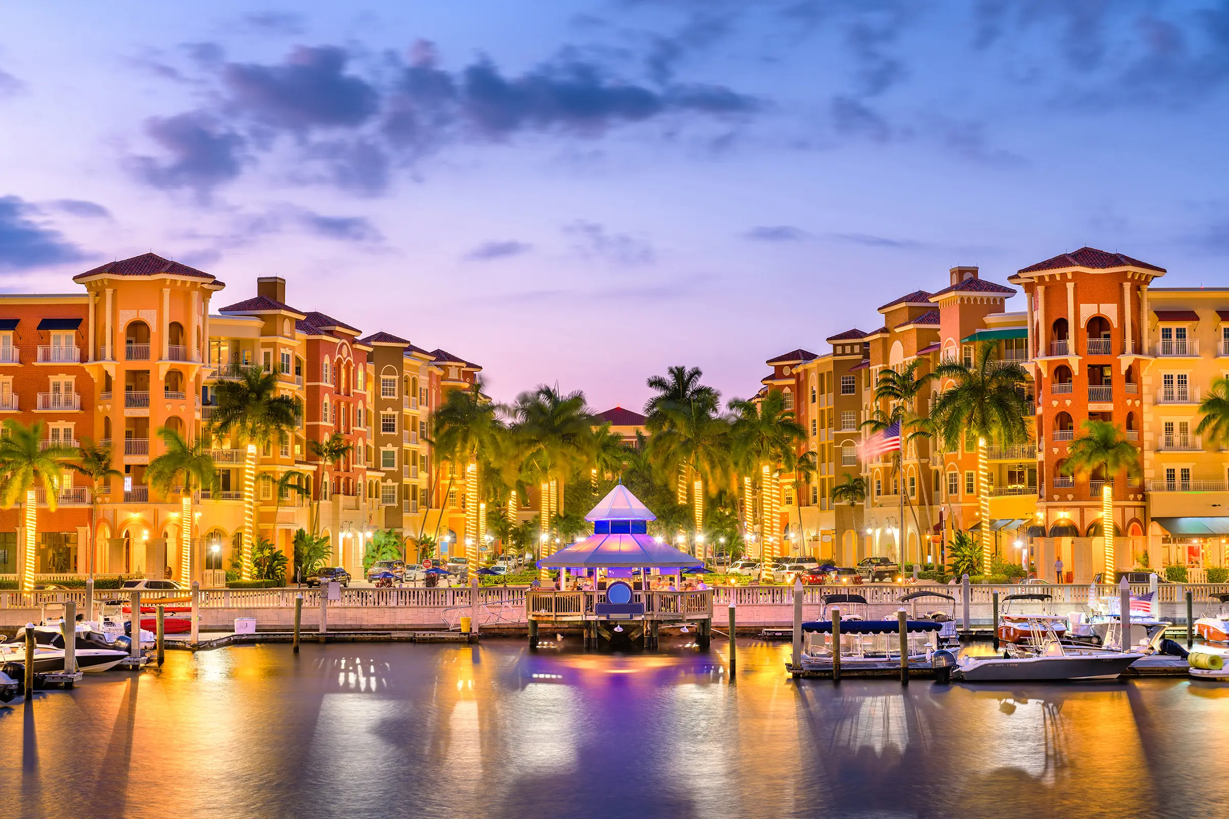 Naples waterfront vacation rentals — Naples Bay marina and Bayfront at dusk