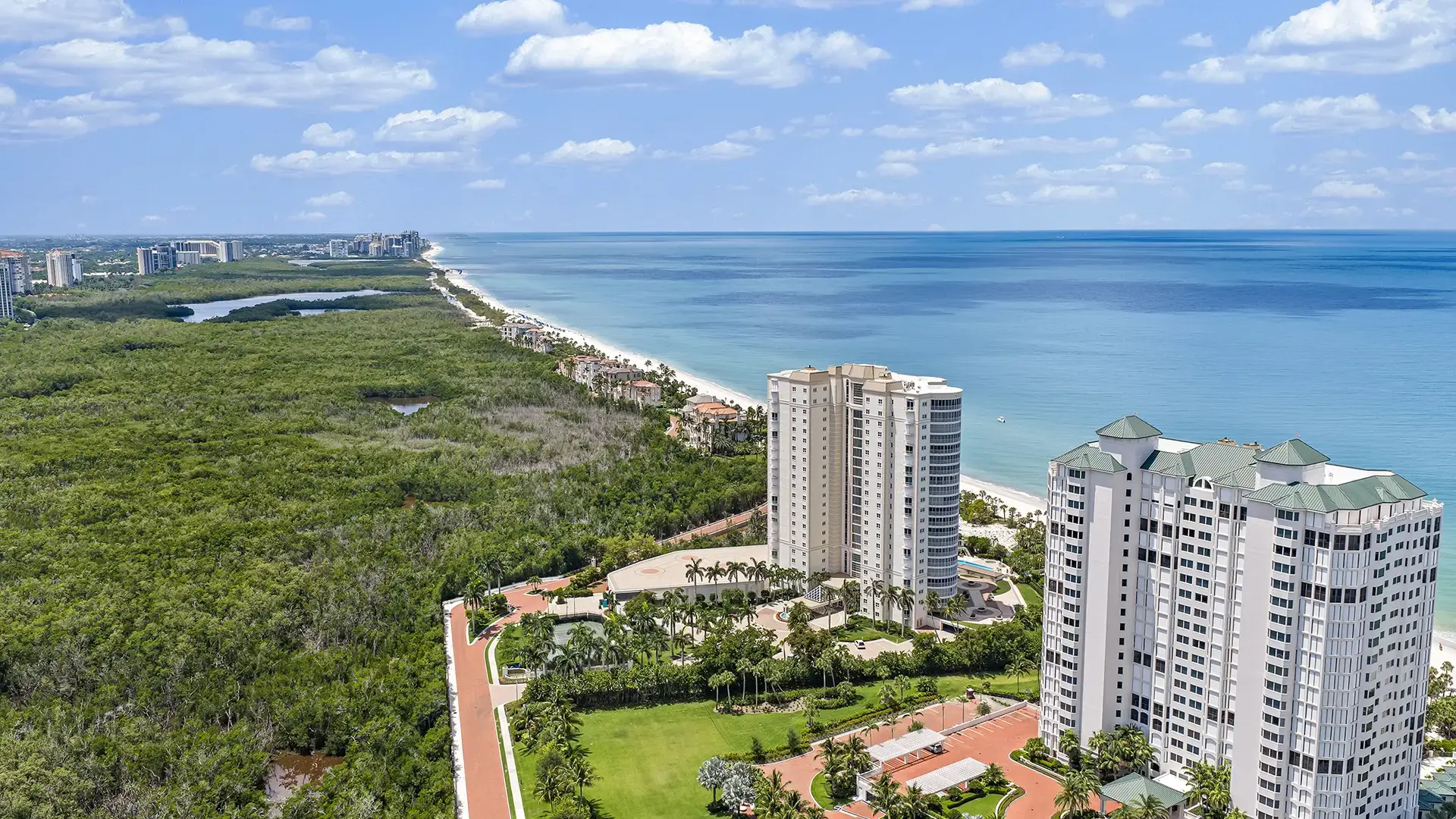 Aerial view of Pelican Bay high-rise condominium towers overlooking the mangrove preserve and Gulf of Mexico in Naples, Florida