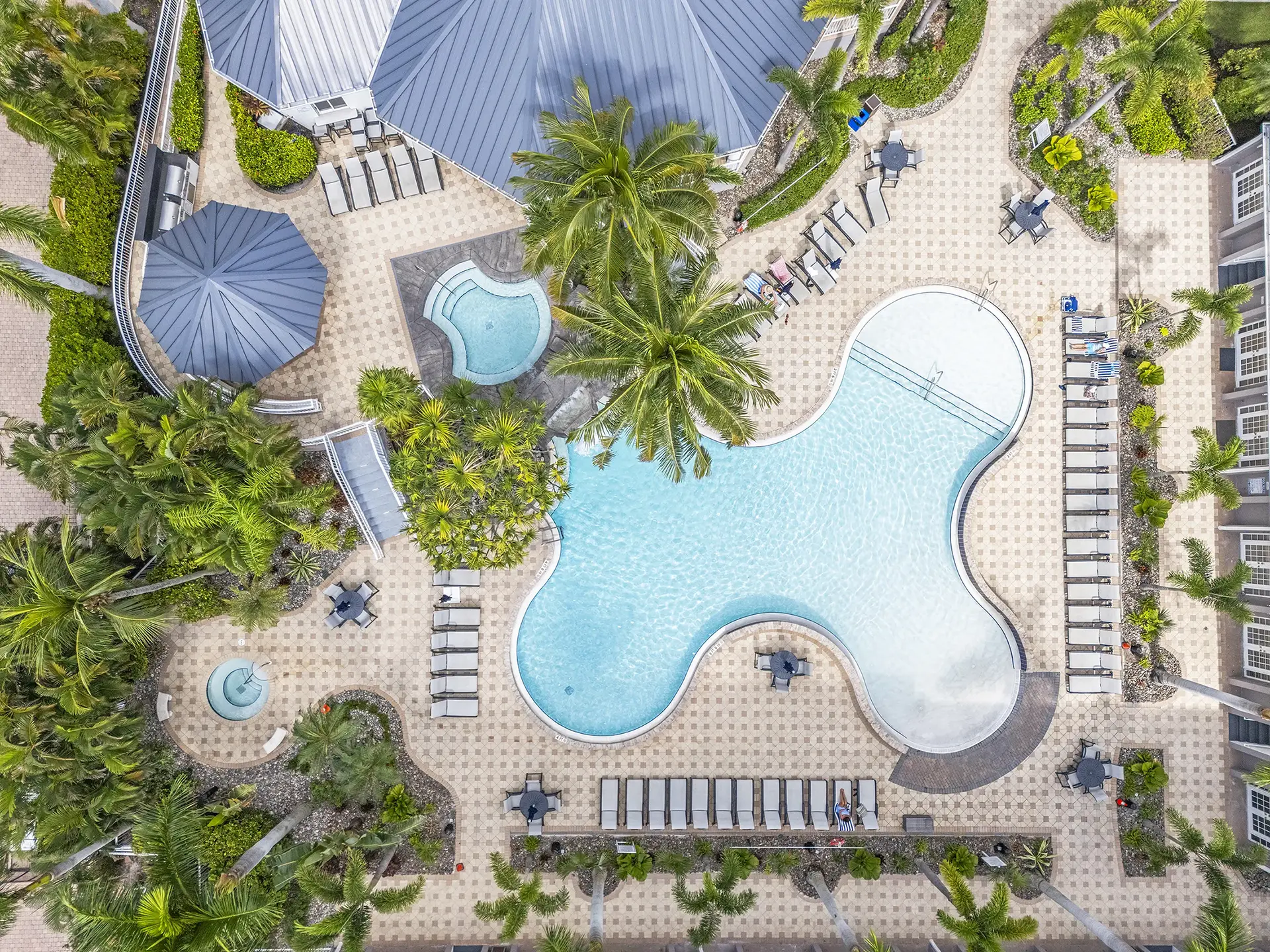 Aerial of the lagoon-style pool, spa and clubhouse at Regatta, Vanderbilt Beach, Naples