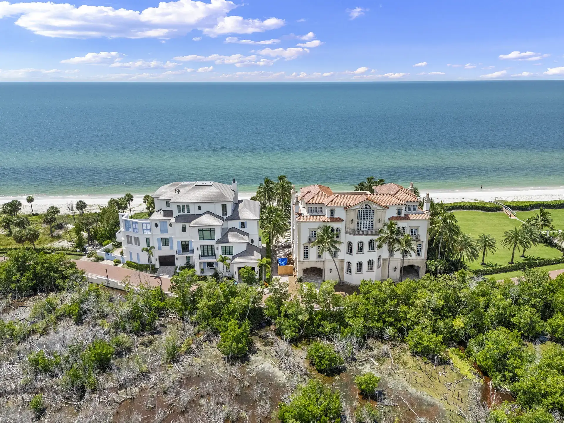 Aerial view of estate homes and pools along the beach at Strand at Bay Colony, Naples, Florida