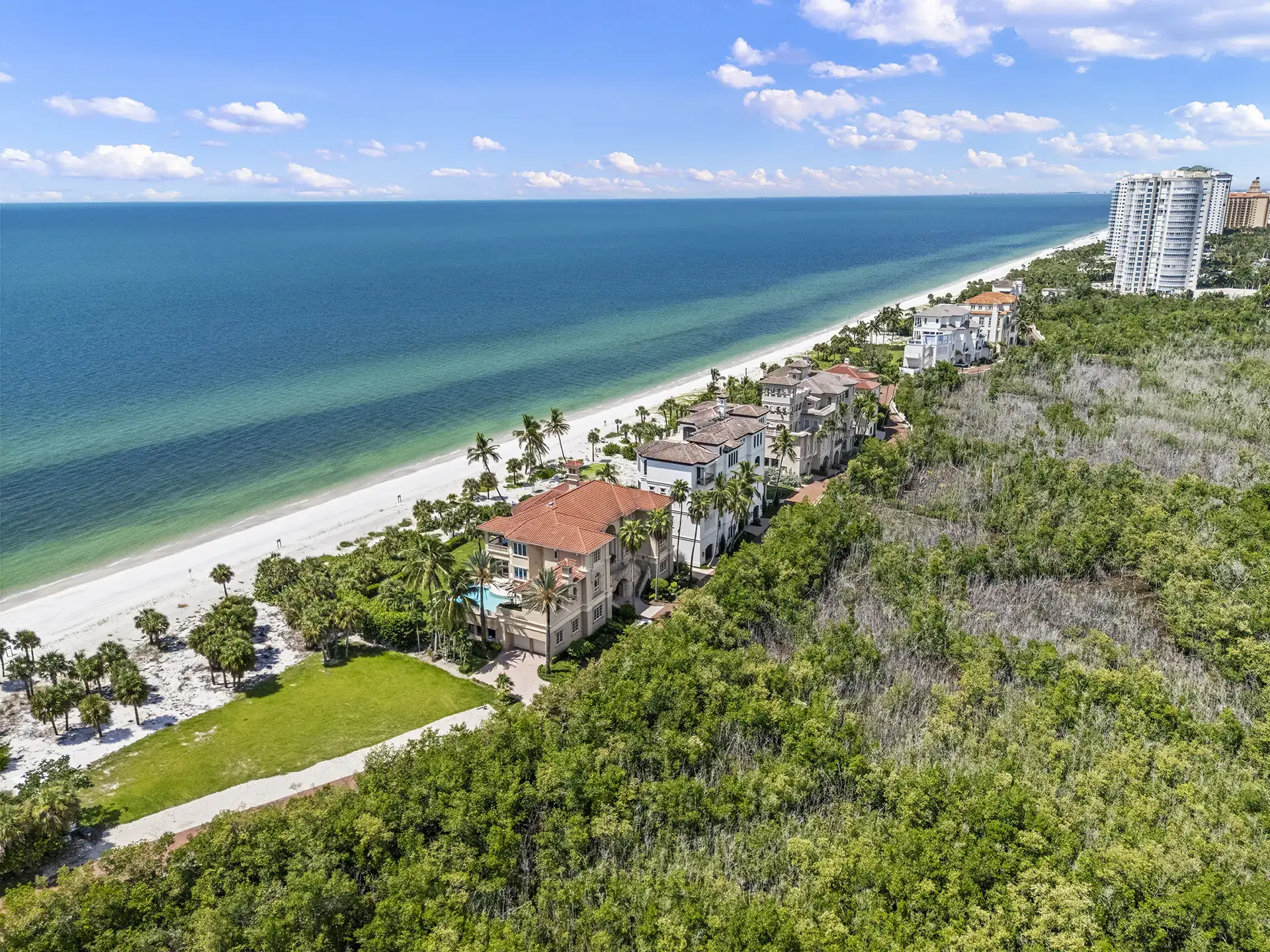 Aerial view of the beachfront estate homes of Strand at Bay Colony on the Gulf of Mexico, Naples, Florida