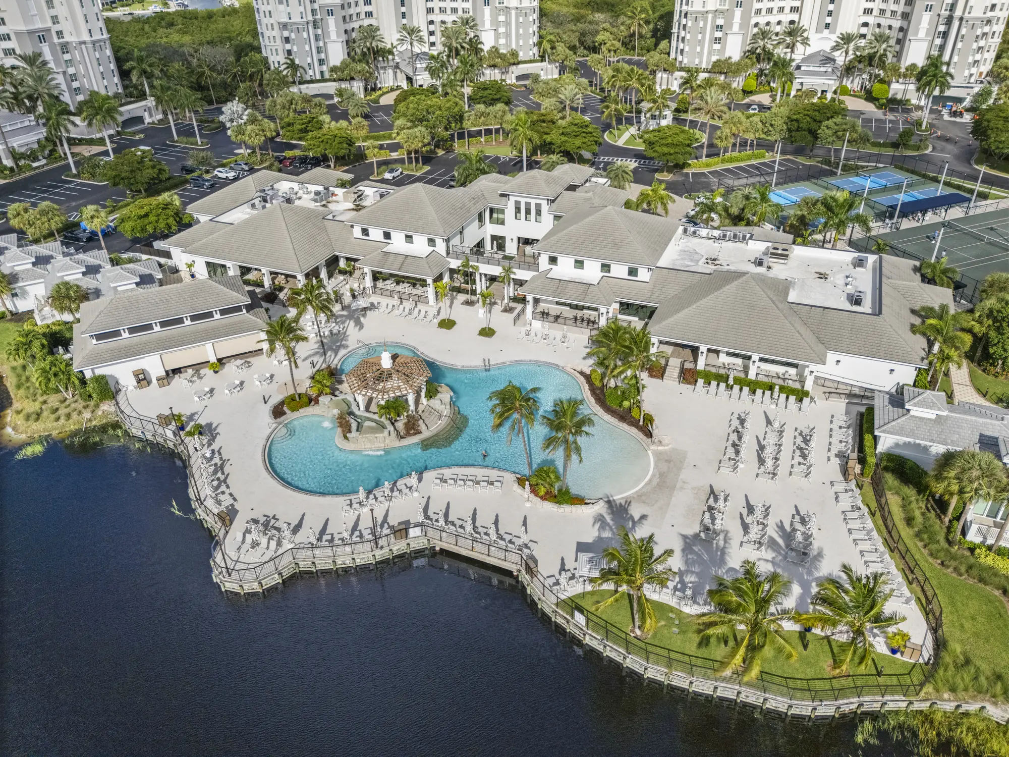 Aerial of the Plantation Club's lagoon pool and clubhouse on the lake at The Dunes of Naples, North Naples, Florida