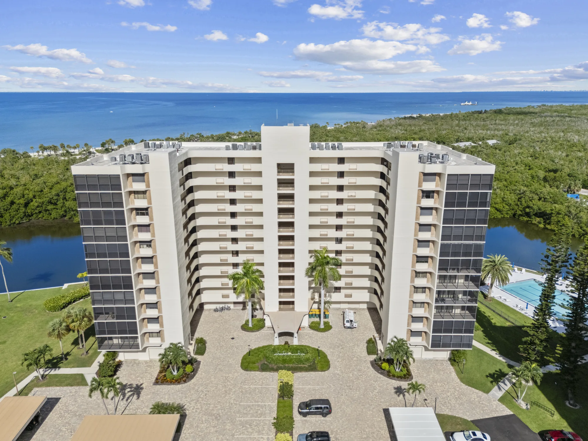 Aerial of Surf Colony II at 15 Bluebill Avenue, an eleven-story Vanderbilt Surf Colony high-rise, with the bay, the mangroves and the Gulf of Mexico beyond, Vanderbilt Beach, Naples, Florida